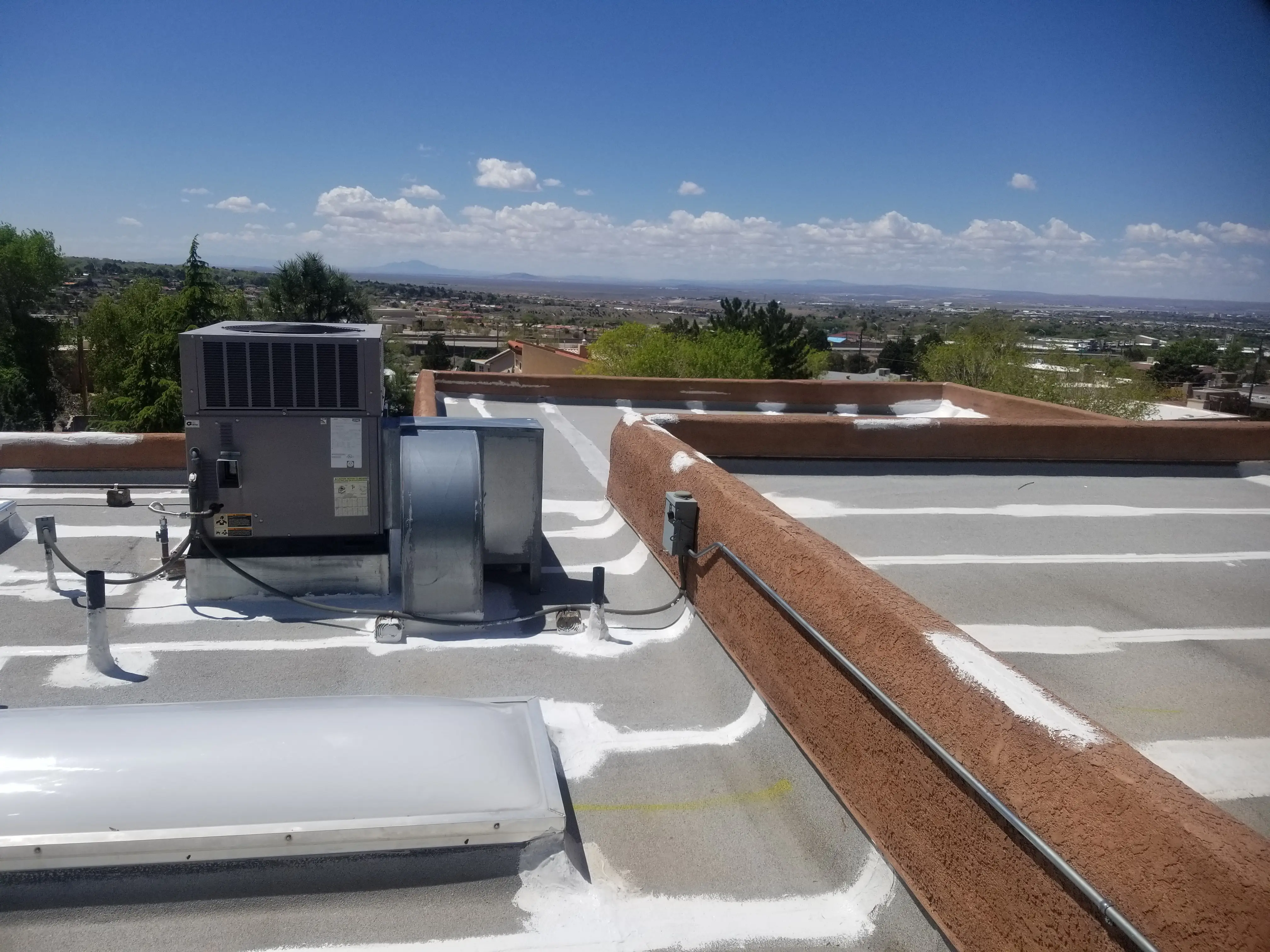 Roof prepared with Armor roof mastic on all seams and flashings — white mastic visible on gray roof material